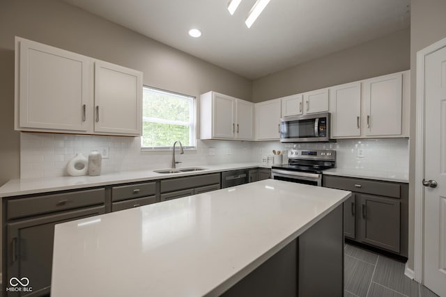 268 Larimar Dr, Whiteland, IN 46184 - kitchen featuring stainless steel appliances, gray cabinetry, light countertops, backsplash, and recessed lighting