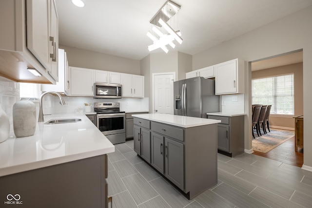 268 Larimar Dr, Whiteland, IN 46184 - kitchen with appliances with stainless steel finishes, gray cabinetry, backsplash, and light countertops
