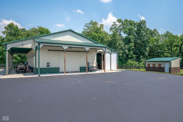 7813 W 50 S, Morgantown, IN 46160 - view of front of home with a garage, an outdoor structure, and view of scattered trees