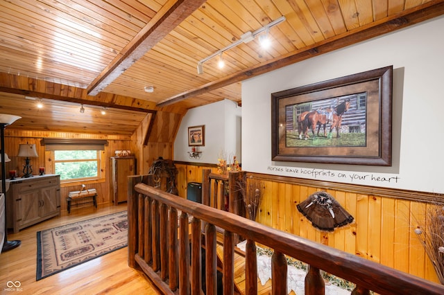 7813 W 50 S, Morgantown, IN 46160 - hall featuring a wooden ceiling with exposed beams, track lighting, an upstairs landing, wood walls, and light wood-style flooring