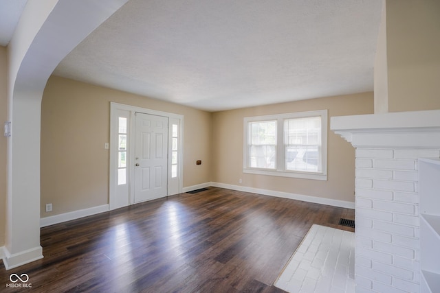 916 E 54th St, Indianapolis, IN 46220 - foyer featuring arched walkways and dark wood-type flooring