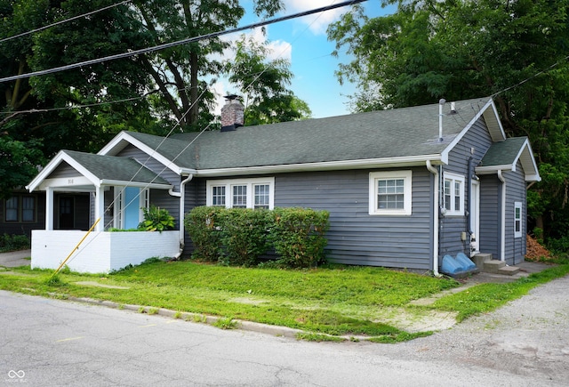 916 E 54th St, Indianapolis, IN 46220 - ranch-style home with a chimney, a front yard, a shingled roof, and entry steps