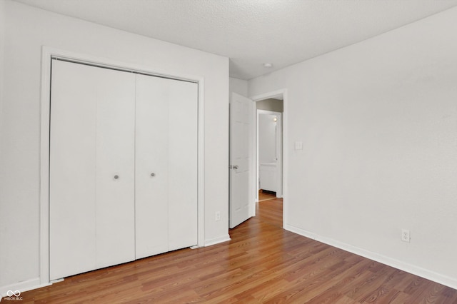 5422 Bluff View Dr, Indianapolis, IN 46217 - unfurnished bedroom featuring light wood-style floors and a closet