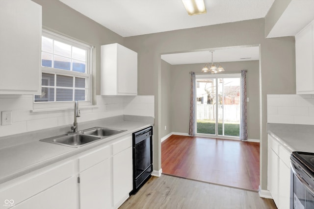5422 Bluff View Dr, Indianapolis, IN 46217 - kitchen featuring black dishwasher, tasteful backsplash, light countertops, and a chandelier