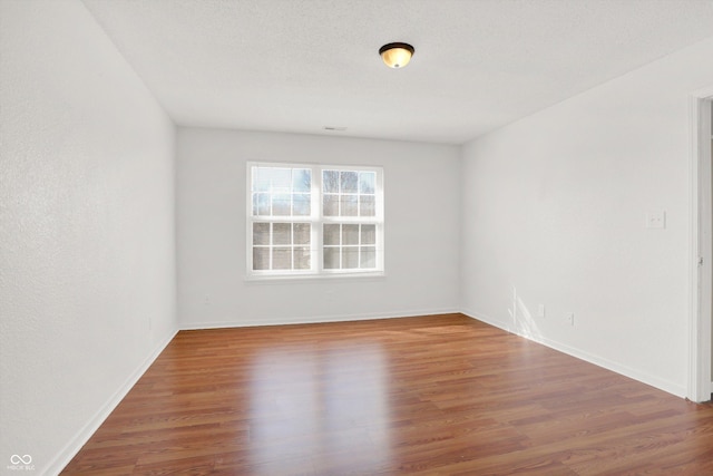 5422 Bluff View Dr, Indianapolis, IN 46217 - spare room featuring wood finished floors and baseboards