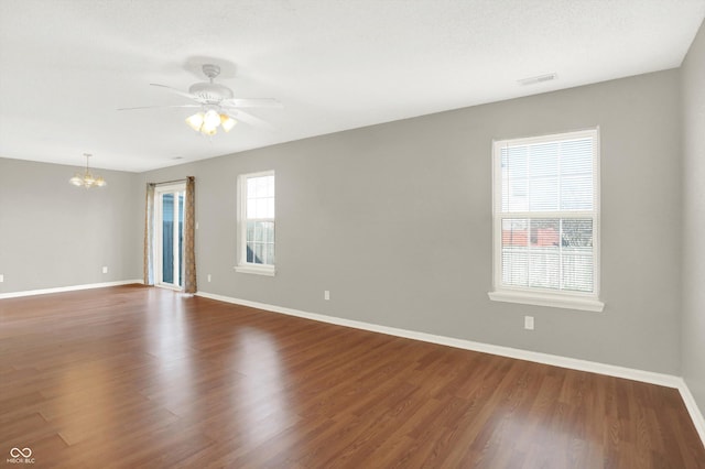 5422 Bluff View Dr, Indianapolis, IN 46217 - empty room with a chandelier, ceiling fan, and dark wood-style flooring