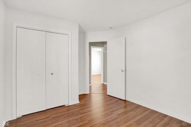 5422 Bluff View Dr, Indianapolis, IN 46217 - unfurnished bedroom with wood finished floors and a closet