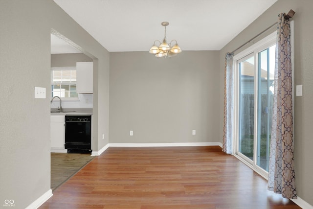 5422 Bluff View Dr, Indianapolis, IN 46217 - unfurnished dining area with a chandelier and light wood finished floors