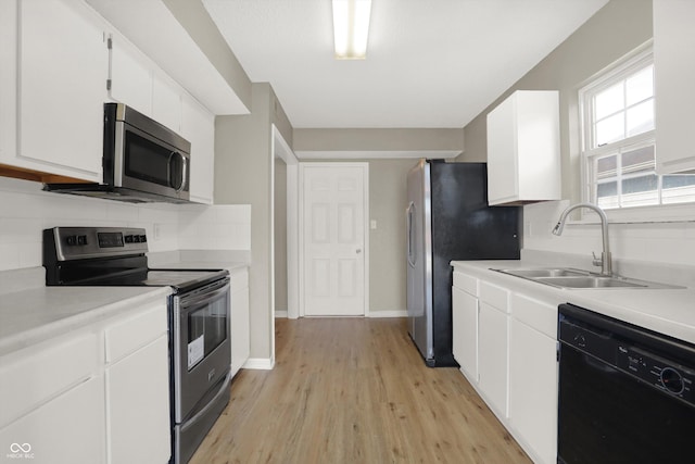 5422 Bluff View Dr, Indianapolis, IN 46217 - kitchen featuring stainless steel appliances, light wood finished floors, light countertops, and white cabinets
