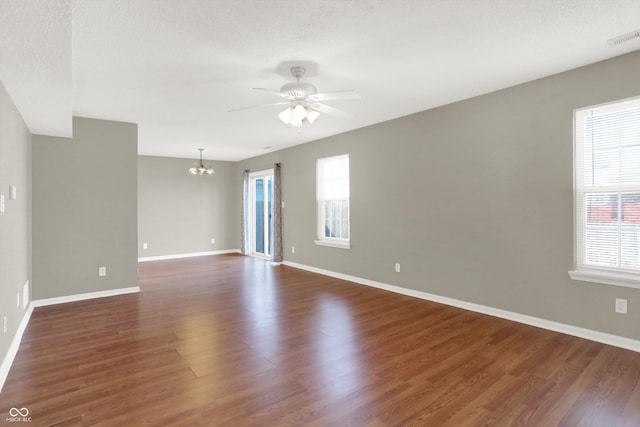 5422 Bluff View Dr, Indianapolis, IN 46217 - spare room with a chandelier, plenty of natural light, wood finished floors, and ceiling fan