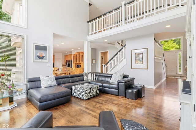 12068 Bayhill Dr, Carmel, IN 46033 - living area with wood finished floors, stairway, a high ceiling, and recessed lighting