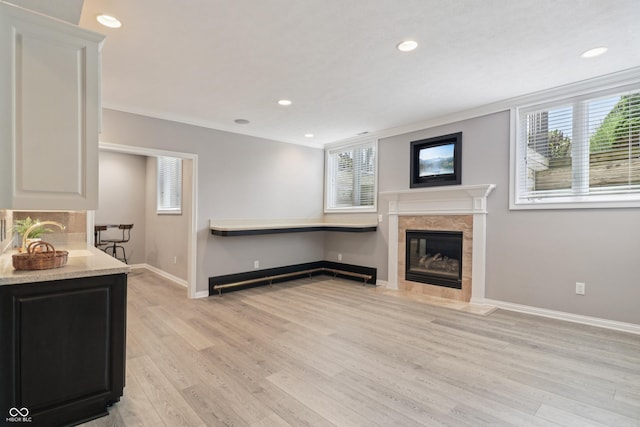 12068 Bayhill Dr, Carmel, IN 46033 - kitchen with a fireplace, light wood-type flooring, white cabinetry, recessed lighting, and crown molding