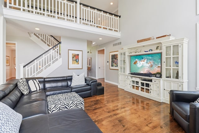 12068 Bayhill Dr, Carmel, IN 46033 - living area with a towering ceiling, wood finished floors, stairs, and recessed lighting