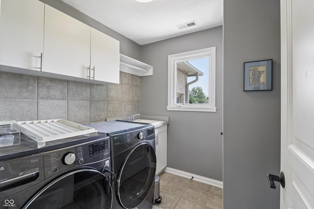 12068 Bayhill Dr, Carmel, IN 46033 - laundry room featuring washing machine and clothes dryer, cabinet space, and light tile patterned floors