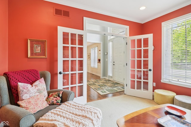 12068 Bayhill Dr, Carmel, IN 46033 - living area featuring plenty of natural light, french doors, wood finished floors, ornamental molding, and recessed lighting