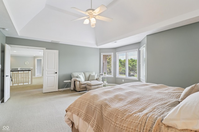 12068 Bayhill Dr, Carmel, IN 46033 - bedroom with light colored carpet, a ceiling fan, vaulted ceiling, and a raised ceiling