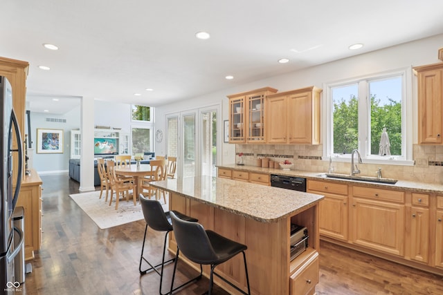 12068 Bayhill Dr, Carmel, IN 46033 - kitchen featuring black dishwasher, recessed lighting, freestanding refrigerator, decorative backsplash, and light stone countertops