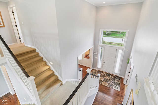 12068 Bayhill Dr, Carmel, IN 46033 - entryway featuring a towering ceiling, crown molding, stairs, and dark wood-type flooring