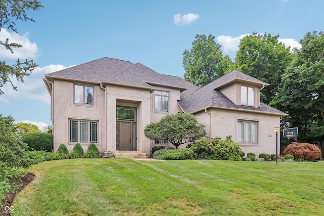 12068 Bayhill Dr, Carmel, IN 46033 - french country home featuring brick siding, a front yard, and a shingled roof