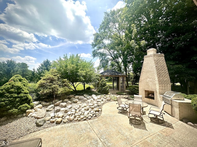 12068 Bayhill Dr, Carmel, IN 46033 - view of patio / terrace featuring an outdoor brick fireplace, a gazebo, and an outdoor kitchen