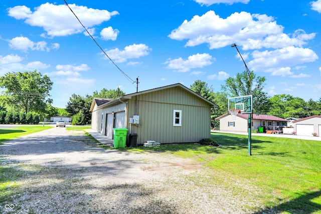 1328 E 600 N, West Lafayette, IN 47906 - view of side of property featuring a yard, a detached garage, an outdoor structure, and board and batten siding