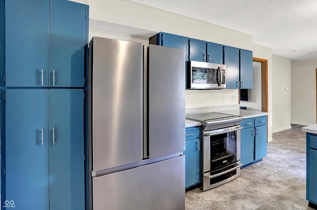 1328 E 600 N, West Lafayette, IN 47906 - kitchen featuring appliances with stainless steel finishes, blue cabinetry, and light countertops
