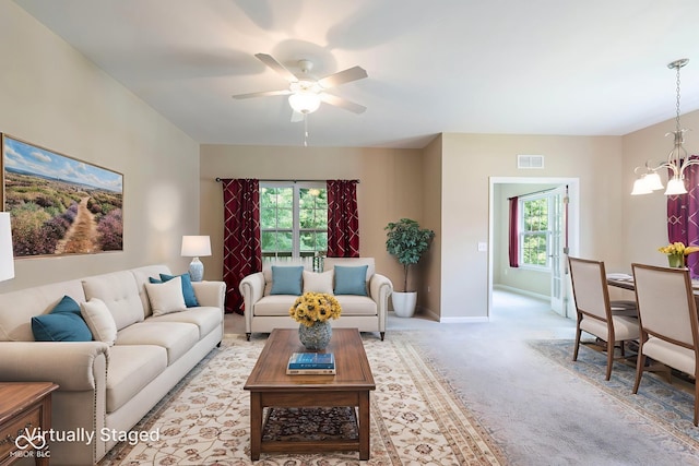 471 Harvest Moon Dr, Greencastle, IN 46135 - living area with a chandelier, plenty of natural light, a ceiling fan, and light colored carpet