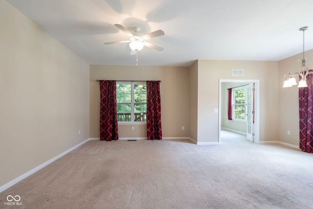 471 Harvest Moon Dr, Greencastle, IN 46135 - carpeted empty room featuring healthy amount of natural light, a ceiling fan, and a chandelier