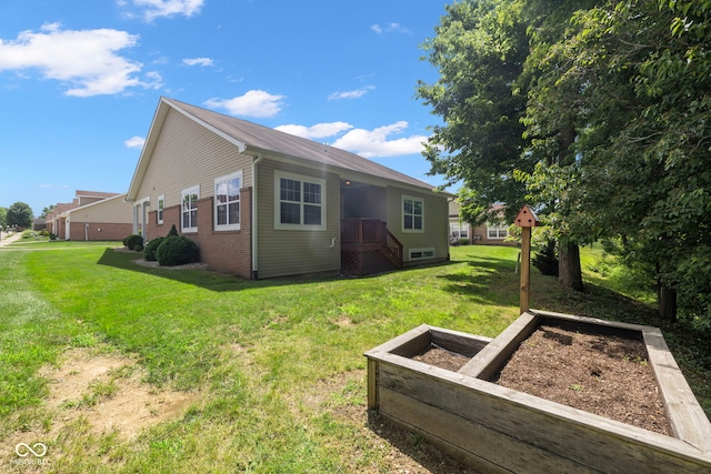 471 Harvest Moon Dr, Greencastle, IN 46135 - rear view of house with a lawn and a garden