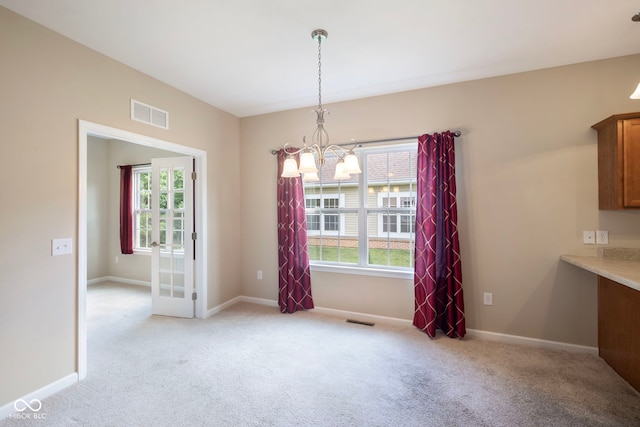 471 Harvest Moon Dr, Greencastle, IN 46135 - unfurnished dining area featuring a chandelier, plenty of natural light, and light colored carpet