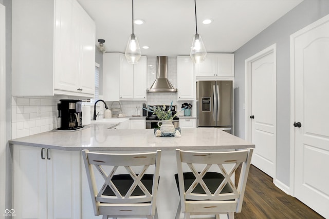 17101 Rushmore Dr, Westfield, IN 46074 - kitchen featuring stainless steel fridge with ice dispenser, wall chimney exhaust hood, range, a peninsula, and backsplash