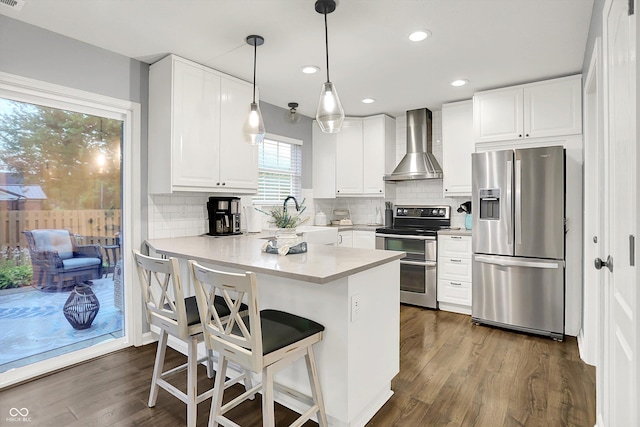 17101 Rushmore Dr, Westfield, IN 46074 - kitchen with appliances with stainless steel finishes, wall chimney exhaust hood, a peninsula, a breakfast bar, and decorative backsplash