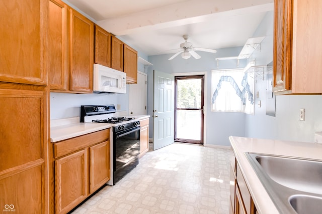 4729 Hittle Dr, Indianapolis, IN 46239 - kitchen with black gas range oven, white microwave, light floors, light countertops, and a ceiling fan