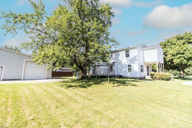 4729 Hittle Dr, Indianapolis, IN 46239 - view of grassy yard with a wooden deck and a garage