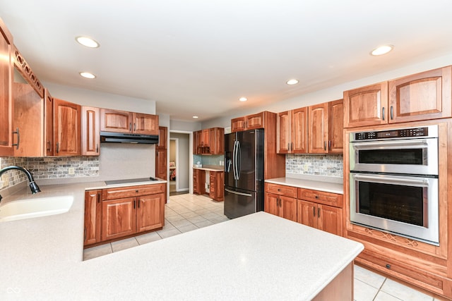 3012 Rollshore Ct, Carmel, IN 46033 - kitchen featuring black appliances, under cabinet range hood, light tile patterned floors, recessed lighting, and light countertops