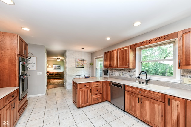 3012 Rollshore Ct, Carmel, IN 46033 - kitchen featuring appliances with stainless steel finishes, a peninsula, light countertops, decorative backsplash, and recessed lighting