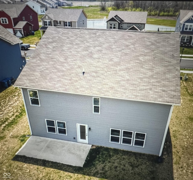 10524 Broadford St, Indianapolis, IN 46239 - rear view of house with a patio, a residential view, a yard, and a shingled roof