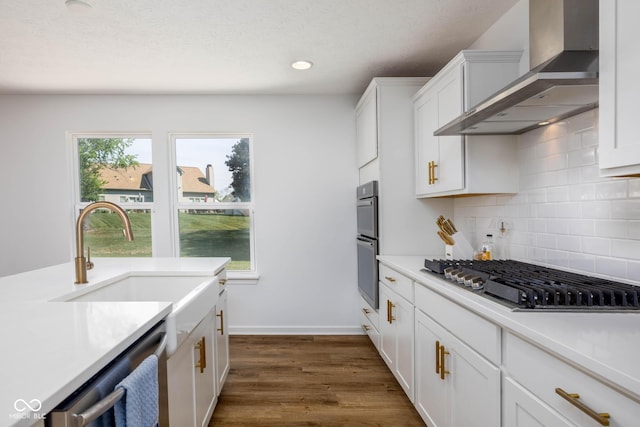 10524 Broadford St, Indianapolis, IN 46239 - kitchen featuring wall chimney range hood, appliances with stainless steel finishes, backsplash, light countertops, and recessed lighting