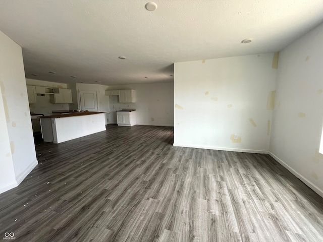1231 Mcbride St, Greenfield, IN 46140 - unfurnished living room featuring dark wood-type flooring and baseboards