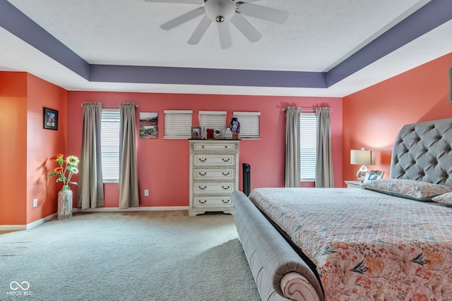 1358 Avocet Dr, Greenwood, IN 46143 - bedroom with a raised ceiling, multiple windows, carpet, a ceiling fan, and a textured ceiling