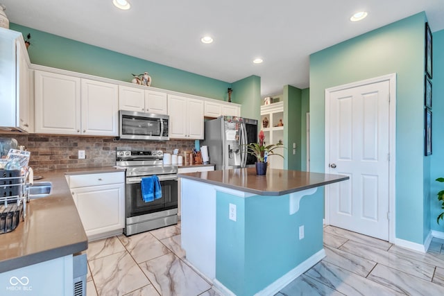 1358 Avocet Dr, Greenwood, IN 46143 - kitchen with appliances with stainless steel finishes, light marble finish flooring, white cabinets, decorative backsplash, and recessed lighting