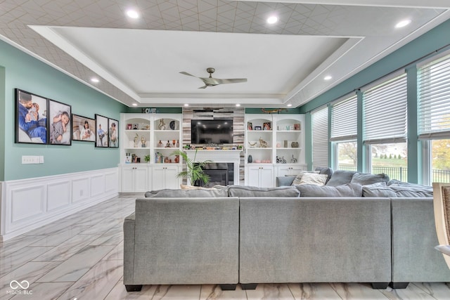 1358 Avocet Dr, Greenwood, IN 46143 - living area featuring a tray ceiling, a large fireplace, ceiling fan, recessed lighting, and built in features