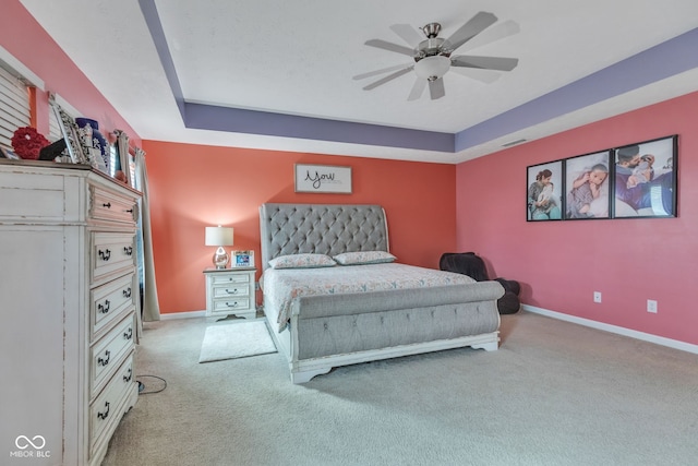 1358 Avocet Dr, Greenwood, IN 46143 - carpeted bedroom featuring a tray ceiling and ceiling fan