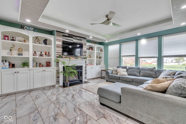1358 Avocet Dr, Greenwood, IN 46143 - living area with a raised ceiling, ceiling fan, a fireplace, recessed lighting, and built in shelves