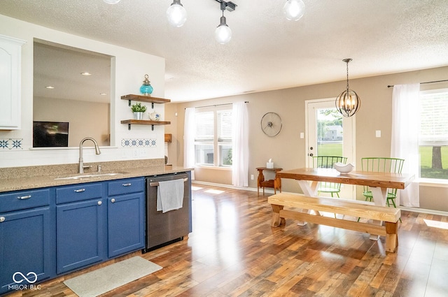 5322 Lily Pad Ln, Indianapolis, IN 46237 - kitchen featuring dishwasher, blue cabinetry, a textured ceiling, light wood finished floors, and plenty of natural light