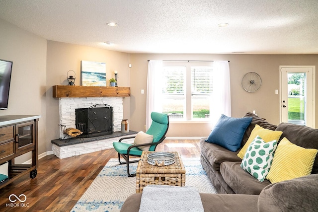 5322 Lily Pad Ln, Indianapolis, IN 46237 - living area featuring a textured ceiling, dark wood-style flooring, a fireplace, and recessed lighting