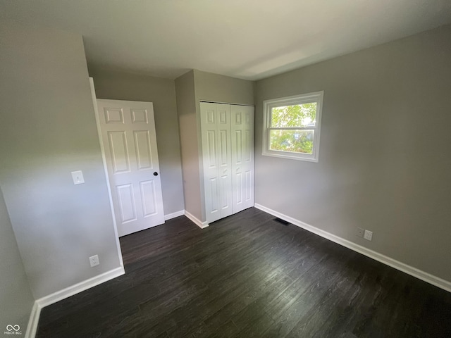 3119 N Fuller Dr, Indianapolis, IN 46224 - unfurnished bedroom featuring dark wood-type flooring and a closet