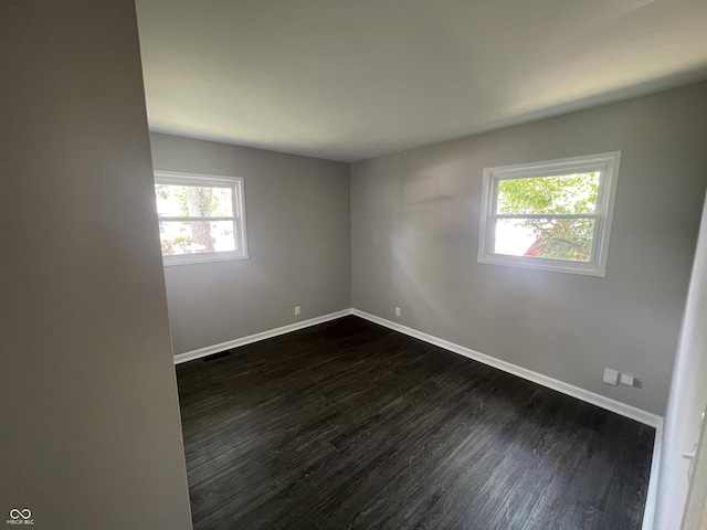3119 N Fuller Dr, Indianapolis, IN 46224 - spare room featuring dark wood-style floors and baseboards
