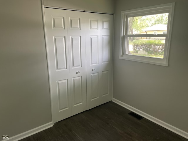 3119 N Fuller Dr, Indianapolis, IN 46224 - unfurnished bedroom featuring a closet and dark wood-type flooring