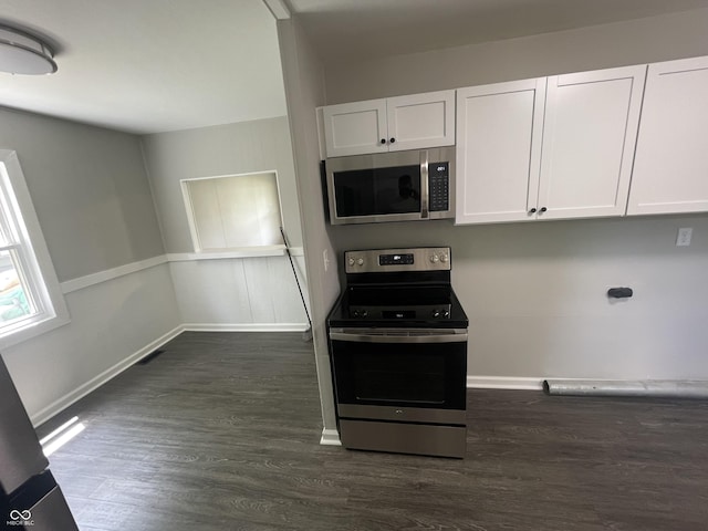 3119 N Fuller Dr, Indianapolis, IN 46224 - kitchen featuring appliances with stainless steel finishes, white cabinets, and dark wood-type flooring